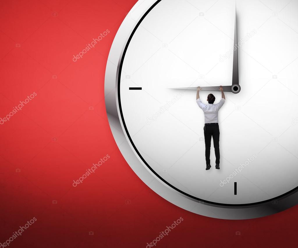 businessman hanging on the clock