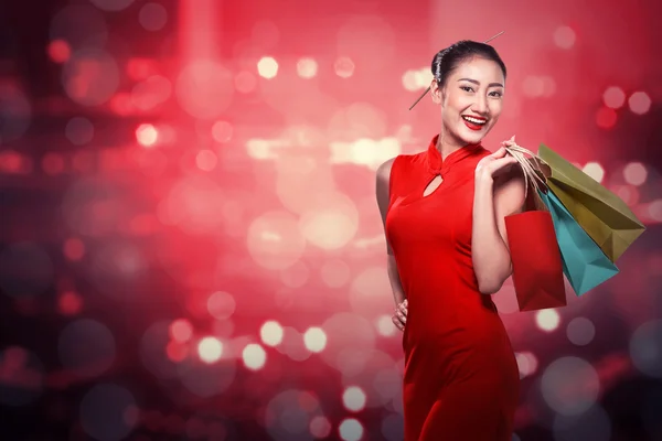 Chinese woman holding shopping bags — Stock Photo, Image