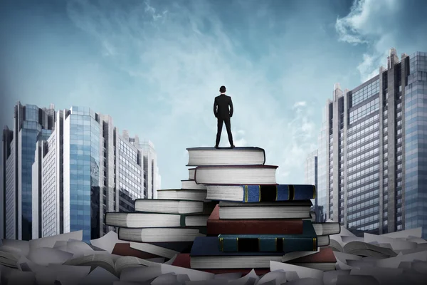 Business man standing on the top of books — Stock Photo, Image