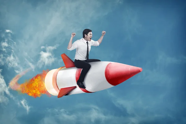 Азіатський бізнесмен літає ракетою — стокове фото