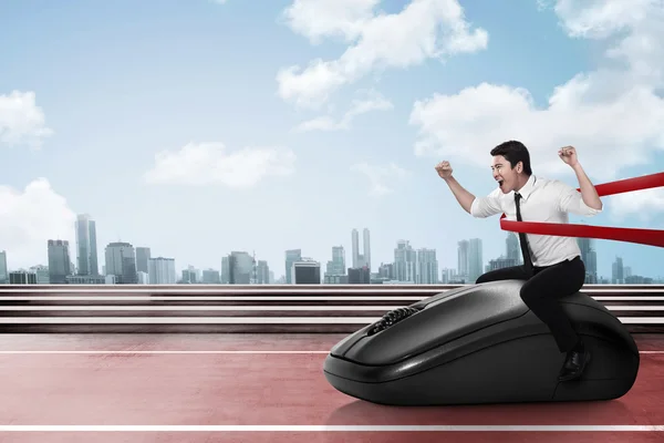 Asian businessman riding computer mouse — Stock Photo, Image