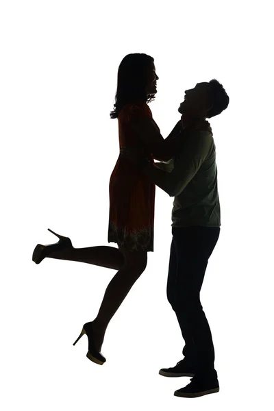 Silhouette of man lifting his girlfriend — Stock Photo, Image