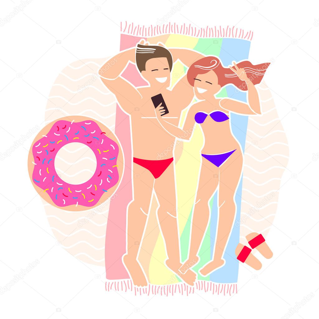 couple in love makes a selfie while lying on the beach. seaside vacations and online communication. relaxing on sea in summer. sunbathe on the sand.