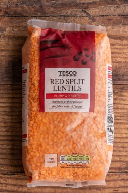 Irvine, İskoçya, İngiltere - 15 Haziran 2021: Tesco, Kcal değerleri ve diğer ilgili bilgilerin yer aldığı sembolleri gösteren kırmızı parçalı mercimeği damgaladı. Plastik torba henüz geri dönüştürülmedi.