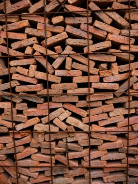 Stacked Red Clay Bricks in Construction Site - Traditional Building Materials Organized in Storage Rows for Architecture Project.