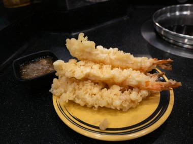 Fresh Golden Crispy Tempura Shrimp Prawns with Dipping Sauce on Yellow Plate - Traditional Japanese Deep Fried Seafood Dish.
