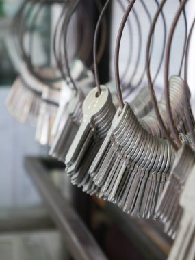 Multiple Duplicate Keys Hanging on Wire Rings at Locksmith Shop - Key Cutting and Duplication Service Business