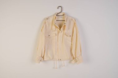 Beige or white jacket on the hanger