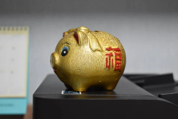 Piggy bank on black computer monitor