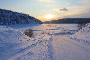 The Lower Tunguska is a river in Eastern Siberia. Winter road on a frozen river in the village of Tura. Evenkia. clipart