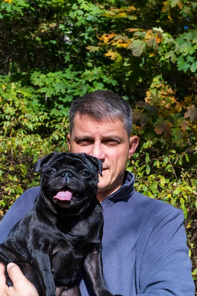Feliz Hombre Mediana Edad Disfrutando Perro Negro Parque Sobre Fondo — Foto de Stock