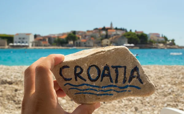 Hand holding a stone with croatia inscription — Stock Photo, Image