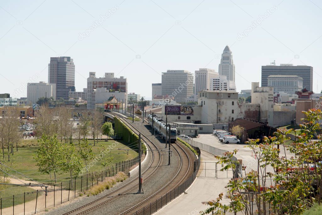 A metro rail light train speeds into Downtown Los Angeles