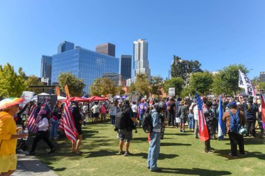 Arkalarında şehir merkezi silueti olan bir grup protestocu. Krallar Yok Protesto, Los Angeles, Gloria Molina Grand Park, 18 Ekim. 