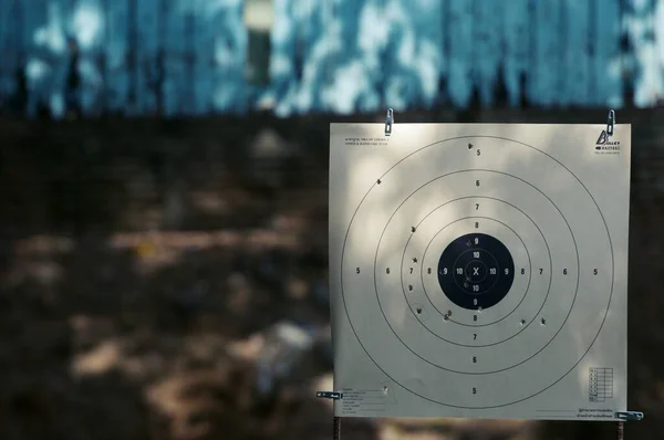 Target practice at outdoor shooting range. paper target and steel plate target