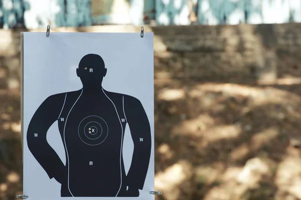 Target practice at outdoor shooting range. paper target and steel plate target