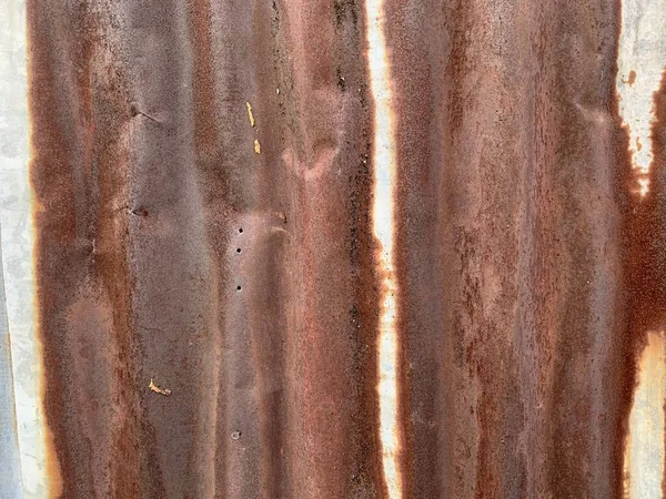 Rusted metal wall. Rusty metal background with streaks of rust. Rust stains.The metal surface rusted spots