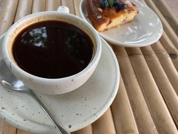 Kuchen Mit Schokoladensauce Und Tasse Schwarzen Kaffee Auf Einem Holztisch — Stockfoto