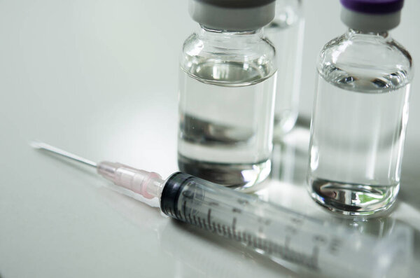 Selective Focus of Syringe and Medicine in vial , ready for vaccine injection , Cancer Treatment , Pain Treatment and can also be abused for an illegal use, healthcare and medical concept vaccination.