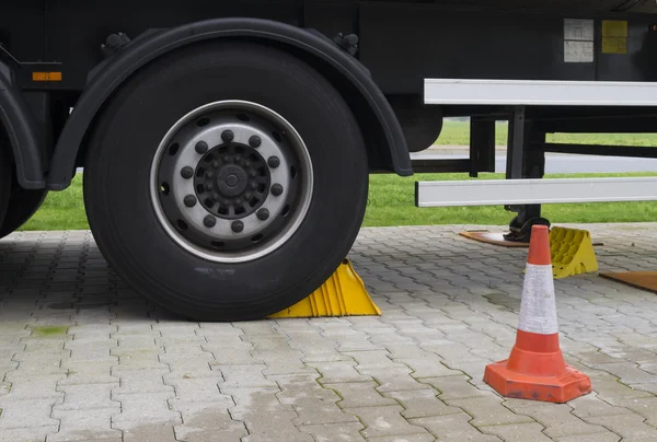 Traffic cone at truck wheel — Stock Photo, Image