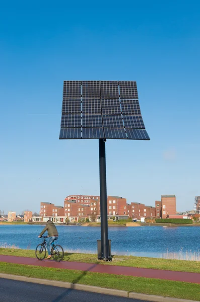 太阳能电池板与骑自行车的人 — 图库照片