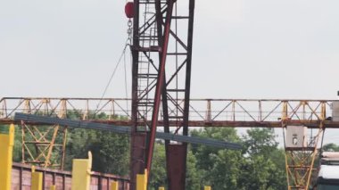 Metal ürünleri vinçle yüklemek, üretimle ilgili bir vincin çalışması, metal ürünlerin depolandığı bir depoda vinç, yakın çekim yapılan bir metal ürünün transferi.