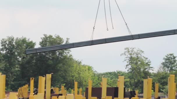 Loading of metal products with a crane, work of a crane on production, a crane in a warehouse of metal products, the transfer of a metal product close-up — Stock Video