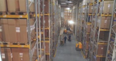 Geniş modern depo panoramik manzarası. Depoda çalışmak için gerekli ekipman. Depoda bir sürü insan çalışıyor..