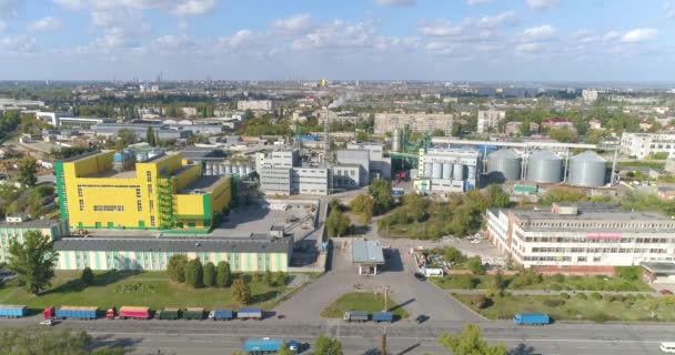 Flying near the yellow factory, beautiful clouds in the background. Large industrial zone in good weather aerial view — Stock Video