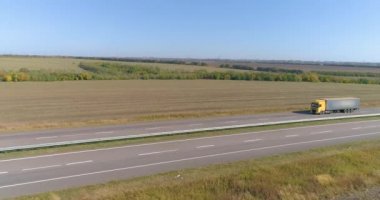 Güneşli havada pistte bir kamyon. Kamyon güzel bir yol boyunca sürüyor. Kargo taşımacılığı