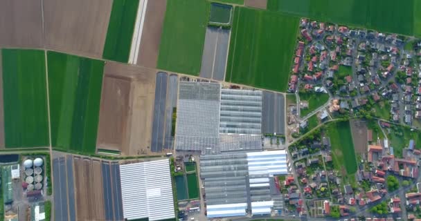 European city near greenhouses, a large greenhouse complex near the European village, Google Maps illusion — Stock Video