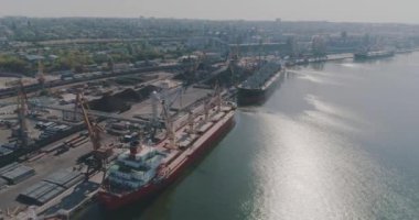 Büyük bir limanın genel planı, liman üzerinde kargo gemileriyle uçmak. İskele vinçleri ve büyük kargo gemileri üzerinde uçmak