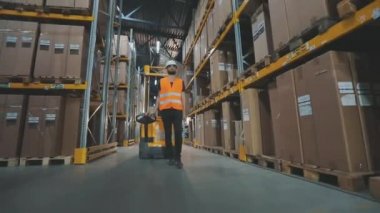 İşçi fabrikanın deposuna gider. Modern bir depoda işçi.