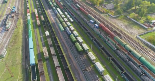 Fly over a large railway junction. Freight trains stand at the railway junction top view — Stock Video