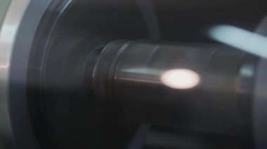 Yakından kayan şaft. Yeni modern ekipmanlar. Modern duvar kağıdı üretimi. Duvar kağıdı üretiminin büyük rulolarını kapat.