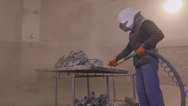 Sandblasting the part. Sandblasting metal parts in a factory. Sandblasting — Stock Video