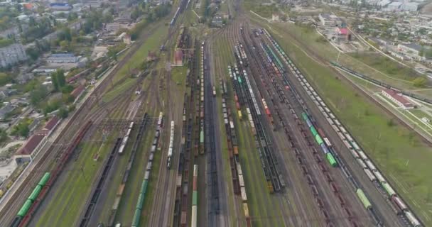 Gekleurde treinen staan in een groot spoorwegdepot. Groot treindepot. Spoorverbinding met veel rails bovenaanzicht. — Stockvideo