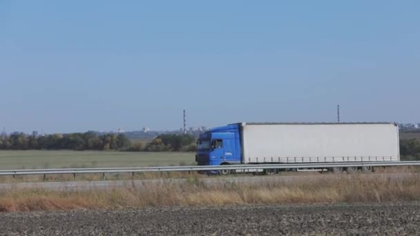 Un camion conduit sur une route en dehors de la ville, un camion cargo moderne conduit sur une autoroute — Video