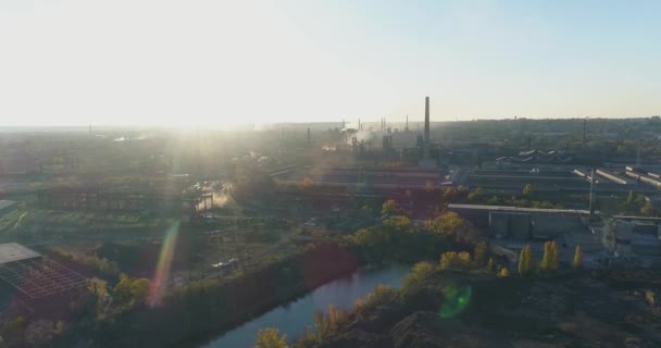 Altın saatinde uzun bacaları olan büyük bir fabrika. Gün batımında büyük bir bitkinin genel manzarası. Metalurjik bitki hava görüntüsü. — Stok video