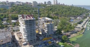 Bir konut kompleksinin inşaatı. Çok katlı bir bina havadan görüntüsü inşa ediliyor. Bir apartmanın inşaat sahasına yakın bir yerde.