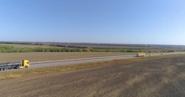 A fuel truck drives along the highway, top view. The truck is driving along the road, view from the drone. Fly over a busy road — Stock Video