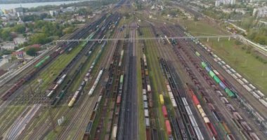 Yük trenlerinin üzerinden uçuyor. Tren yolu manzaralı. Güneşli havada sanayi demiryolu kavşağı