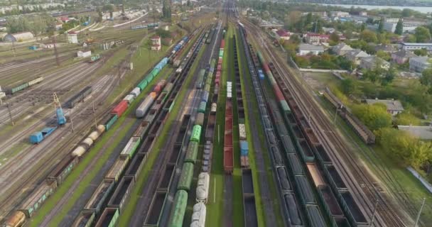 Large industrial railway depot. Trains are parked at the depot at the railway junction. Many colored trains — Stock Video