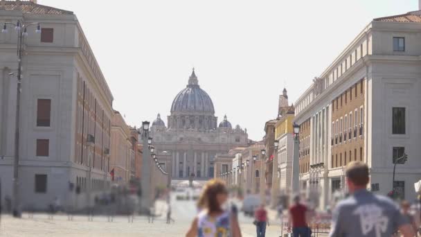 People go to Saint Peters Basilica. Street leading to Saint Peters Basilica in Vatican, Rome, Italy