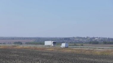 Şehrin dışındaki kamyonların geçtiği yol. Kamyon yolda gidiyor.