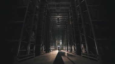 Fabrikada sabah bir adam depodan geçerken ışığı yanıyor. Fabrika deposunun ışıklarını açmak.