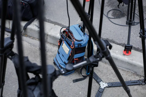 Live video transmission and live streaming equipment in a backpack used by TV cameramans, between tripods.