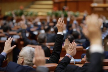 Bükreş, Romanya - 17 Şubat 2021: Romen milletvekillerinin ellerini kaldırarak oy vermelerinin ayrıntılarıyla sığ alan derinliği (seçici odak).