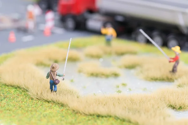 Miniature anglers near road — Stock Photo, Image