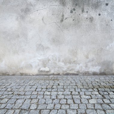 grunge urban background, old wall texture bright plaster and blocks road sidewalk abandoned exterior urban background for your concept or project